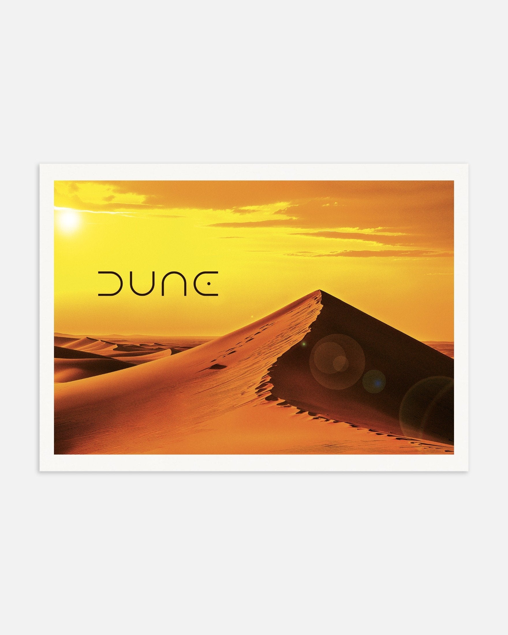 Desert landscape with sand dunes and 'Dune' text on a yellow sky
